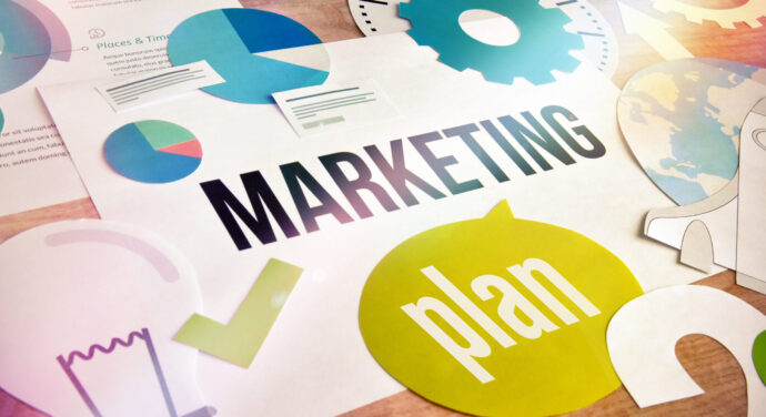 Marketing Plan surrounded by gears and charts and lightbulb graphics